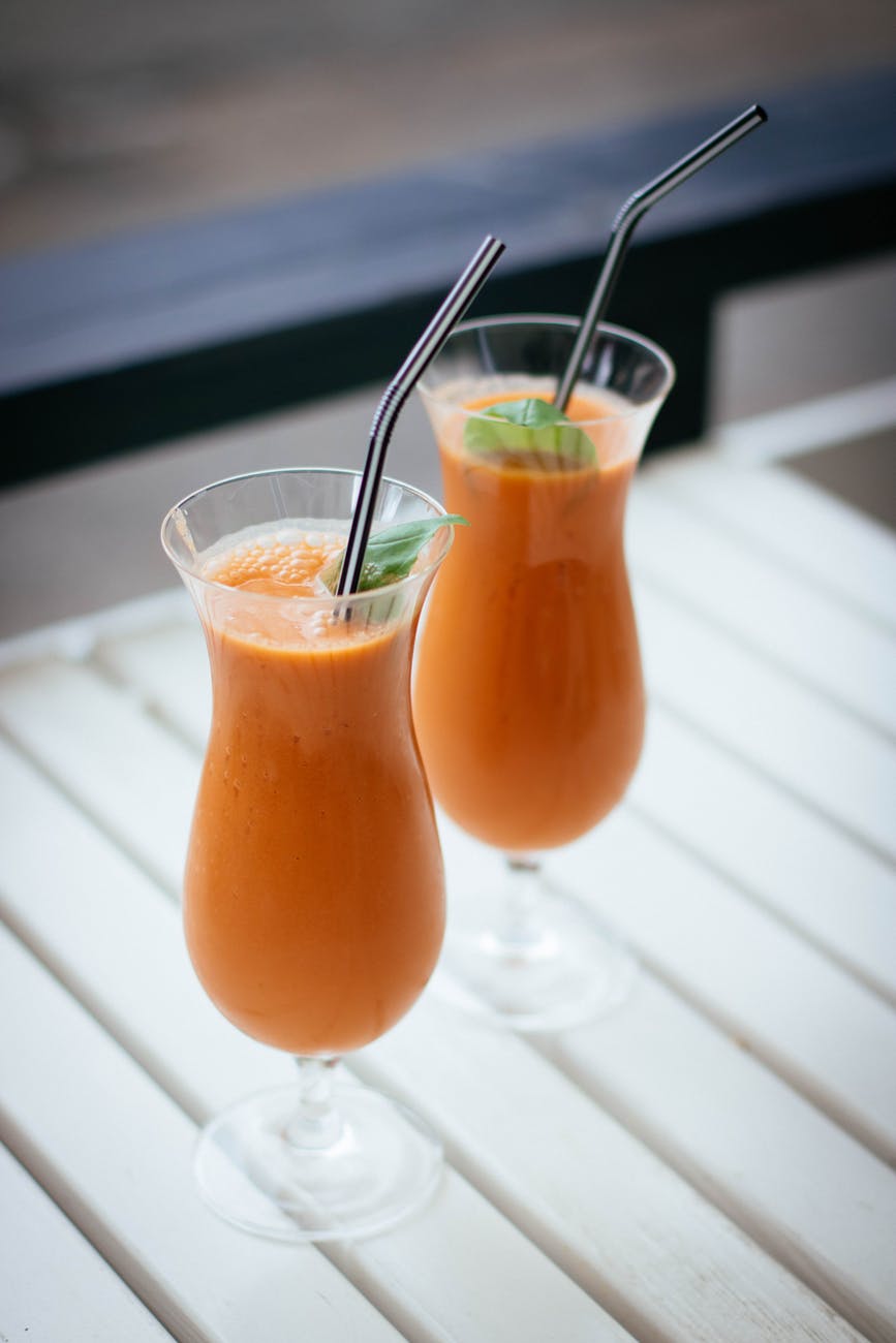 selective focus photography of two orange drinks