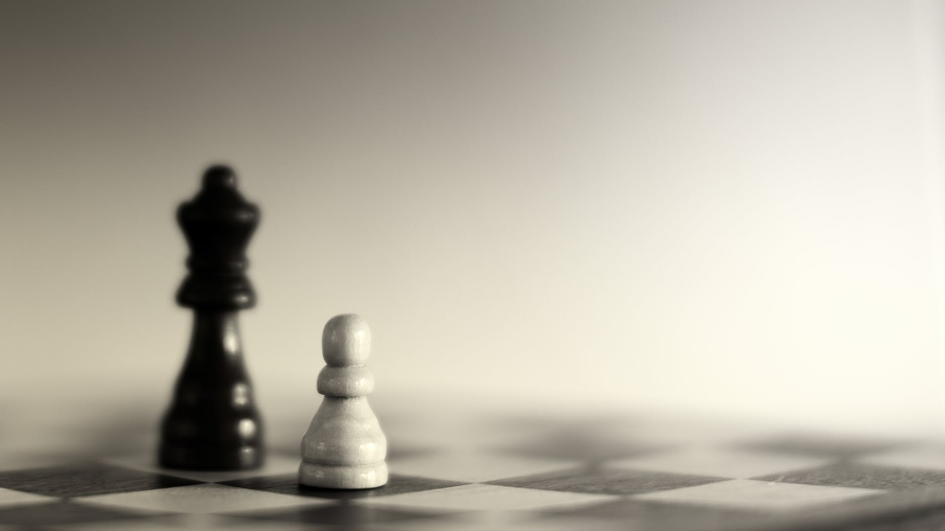grayscale photography of two chess pieces