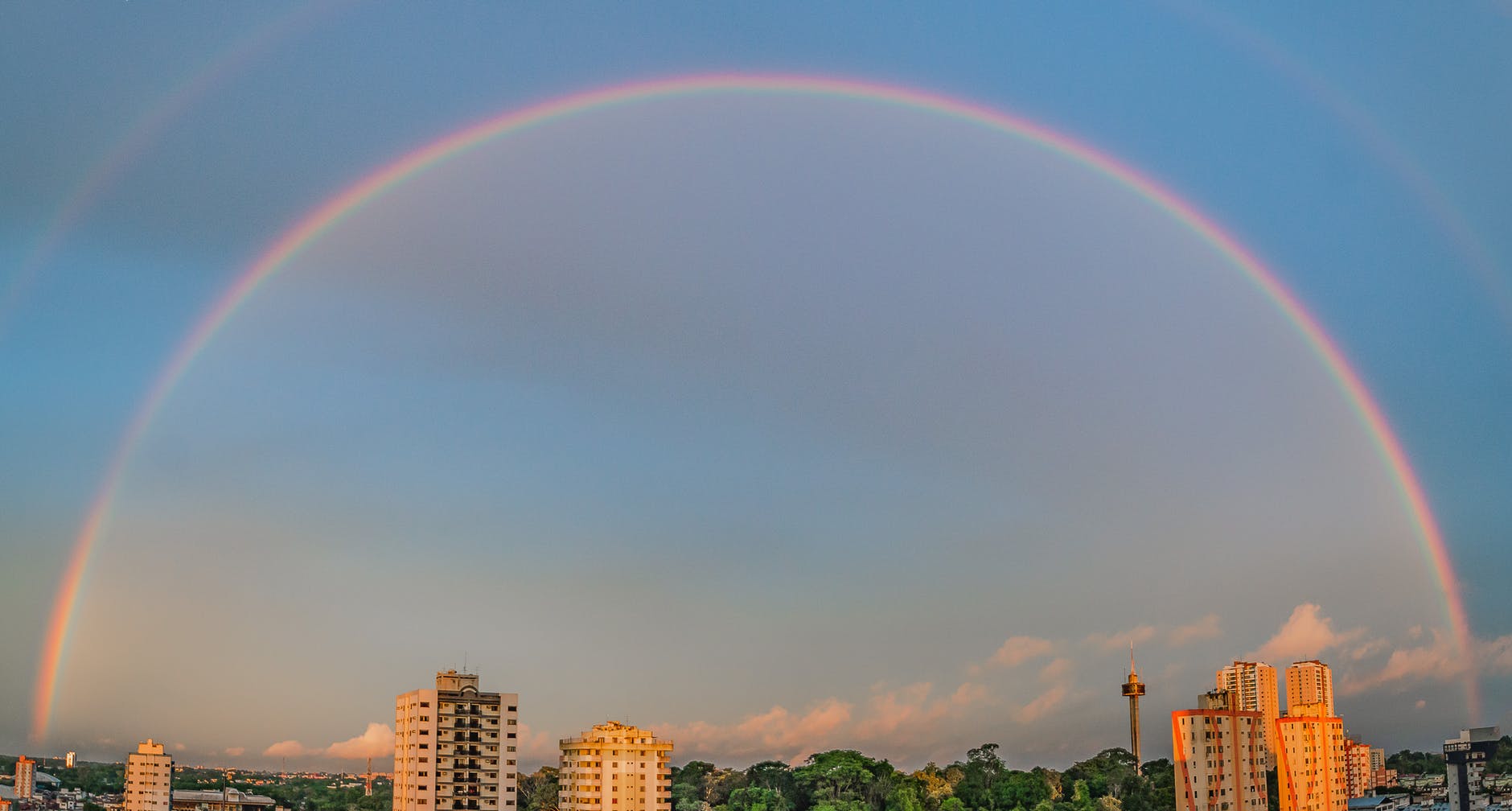 rainbow over high rise buildings