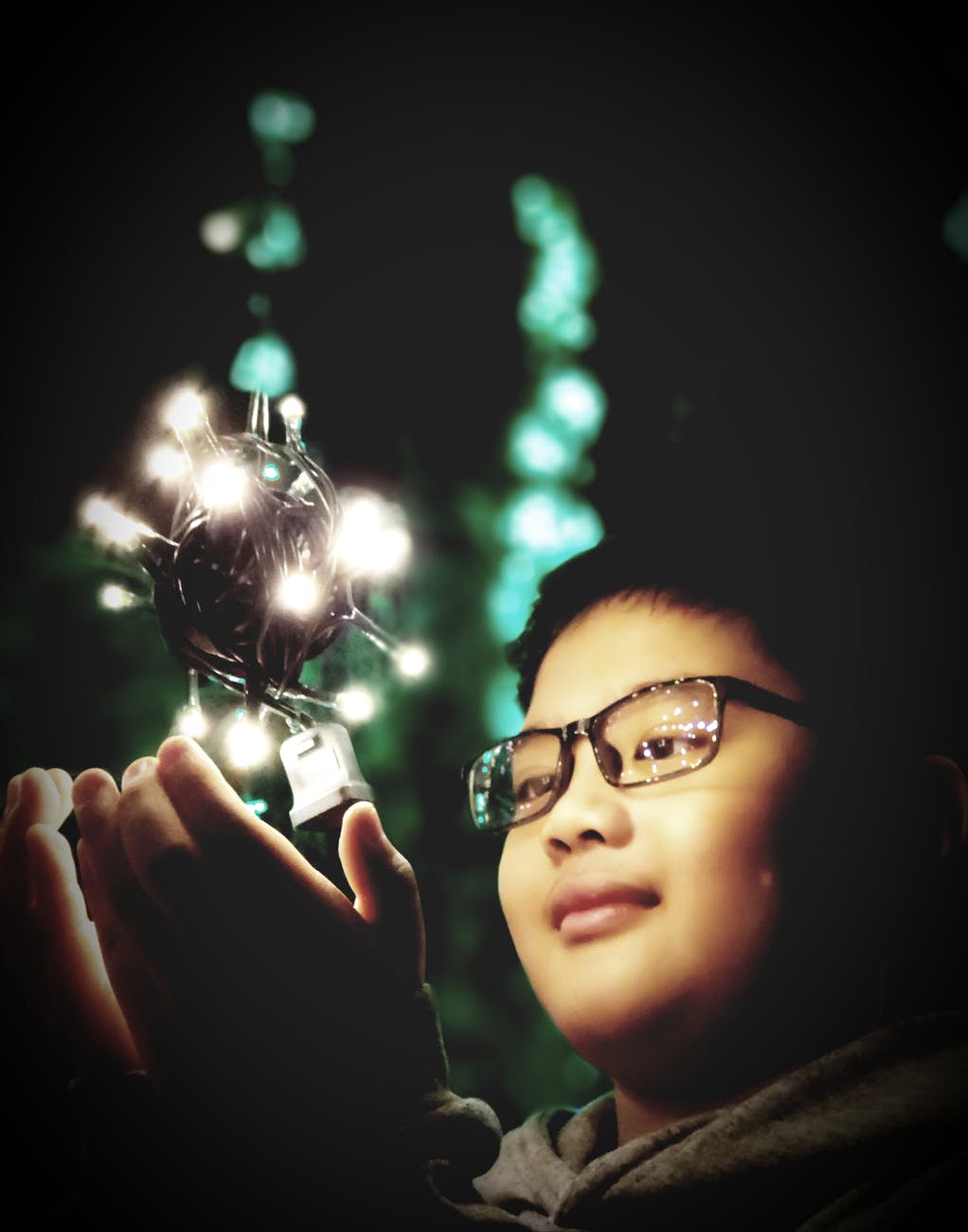 boy touching black and white string light