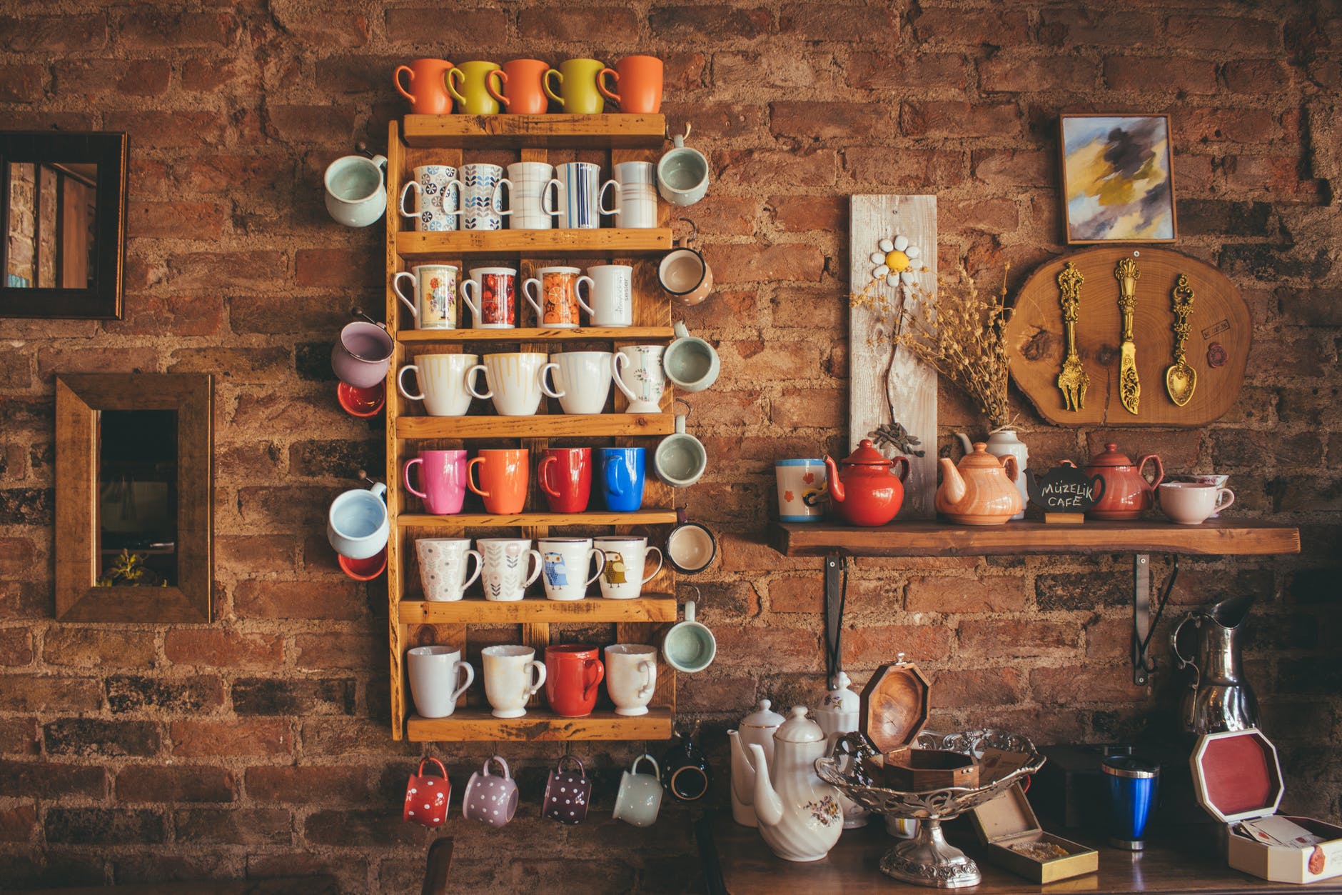assorted color mugs on brown wooden floating rack